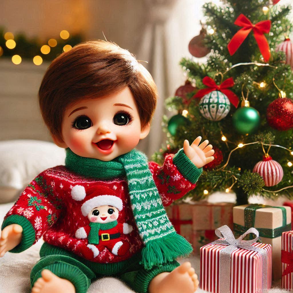225+ Best Baby Doll Whatsapp Dp 176 A cheerful baby doll dressed in a red and green festive outfit, sitting next to a decorated Christmas tree